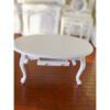 Miniature Victorian-style white oval table with carved legs and drawer