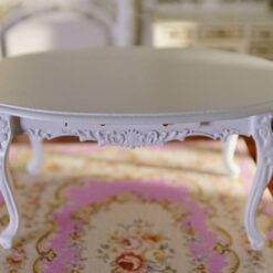 Miniature Louis XV-style white oval dining table with carved legs