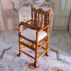 Victorian-style miniature wooden high chair with fabric seat