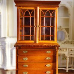 Miniature hutch with glass doors and a polished wood finish.