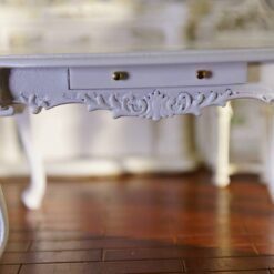 Miniature Louis XV-style white oval dining table with carved legs