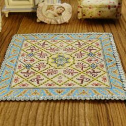 Miniature classic Aubusson rug with floral design and intricate border.