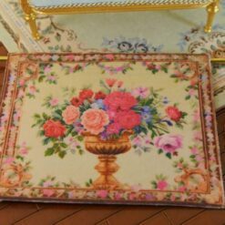 Golden urn filled with roses and flowers framed by an intricate floral border, a miniature Aubusson tapestry