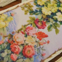 Wildflower bouquet and roses climbing a trellis in soft pastel hues, a miniature Aubusson tapestry.