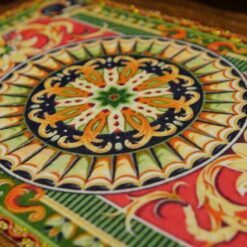 A unique Aubusson miniature rug featuring a floral medallion in rich, warm tones, ideal for vintage dollhouses.