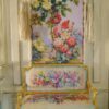 Wildflower bouquet and roses climbing a trellis in soft pastel hues, a miniature Aubusson tapestry.