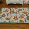 Miniature modern floral rug with bright colors and intricate flower patterns.