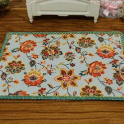 Miniature modern floral rug with bright colors and intricate flower patterns.