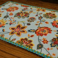 Miniature modern floral rug with bright colors and intricate flower patterns.