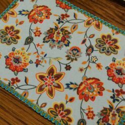 Miniature modern floral rug with bright colors and intricate flower patterns.