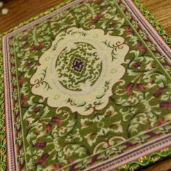 Miniature modern Persian rug in olive green with geometric and floral pattern.