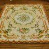 Miniature Victorian rug with floral design in muted tones.