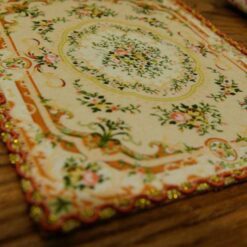 Miniature Victorian rug with floral design in muted tones.