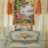 Tree with blooming roses beside a river framed with golden tones, a miniature Aubusson tapestry.