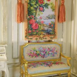 Tree with blooming roses beside a river framed with golden tones, a miniature Aubusson tapestry.