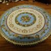 Miniature Victorian floral rug with delicate flowers and ornate borders.