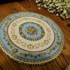 Miniature Victorian floral rug with delicate flowers and ornate borders.