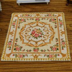 Miniature red and yellow Victorian rug with rose and scroll design.