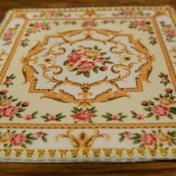 Miniature red and yellow Victorian rug with rose and scroll design.