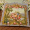 Basket filled with roses and wildflowers with a scenic backdrop in a miniature Aubusson tapestry.