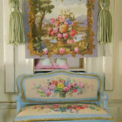 Basket filled with roses and wildflowers with a scenic backdrop in a miniature Aubusson tapestry.
