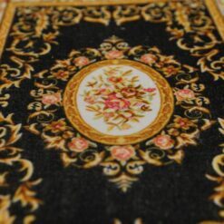 A Persian miniature rug with intricate floral design, perfect for dollhouses.