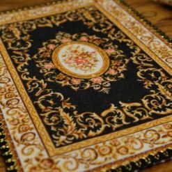 A Persian miniature rug with intricate floral design, perfect for dollhouses.A Persian miniature rug with intricate floral design, perfect for dollhouses.