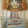 Charming Village Scene 1 Quaint village scene framed by trees and vibrant floral borders in a miniature Aubusson tapestry.