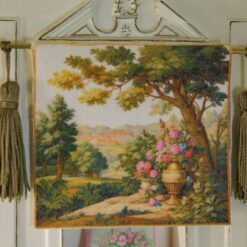 Countryside scene with golden urn, roses, and lush greenery in a miniature Aubusson tapestry.