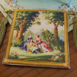 Miniature Aubusson tapestry with three figures in a forest setting, surrounded by trees and delicate blossoms.