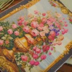 Golden vase overflowing with roses and wildflowers framed by intricate gold, a miniature Aubusson tapestry.