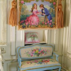 A romantic proposal scene with a couple in vintage attire, surrounded by roses and framed with gold, a miniature Aubusson tapestry.