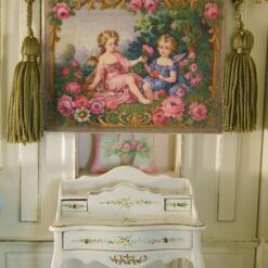 Two cherubs in a rose garden framed by ornate golden details, a miniature Aubusson tapestry.