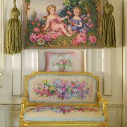 Two cherubs in a rose garden framed by ornate golden details, a miniature Aubusson tapestry.