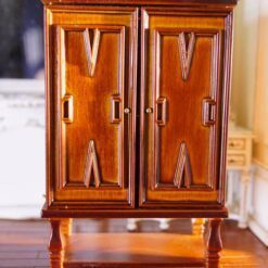 This walnut wardrobe for dollhouses features intricate carvings, double doors, and a polished finish, perfect for adding elegance to Vintage-style interiors. 9 Vintage miniature walnut wardrobe with carved details