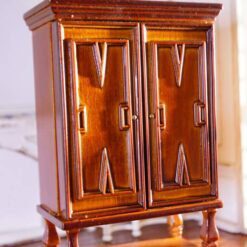 This walnut wardrobe for dollhouses features intricate carvings, double doors, and a polished finish, perfect for adding elegance to Vintage-style interiors. 13 Vintage miniature walnut wardrobe with carved details