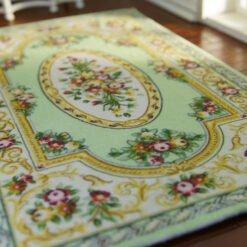 Green Victorian floral rug with gold and pink accents