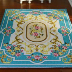 Blue Aubusson rug with floral patterns and scroll designs