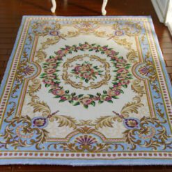 Modern Aubusson rug in blue with floral motifs and a sophisticated design.