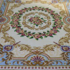 Modern Aubusson rug in blue with floral motifs and a sophisticated design.
