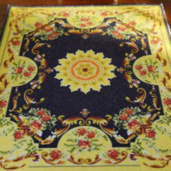 Dark blue Aubusson rug with floral border and central medallion design.