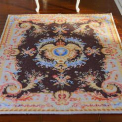 Miniature Royal Savonnerie Aubusson rug with floral and crest design.