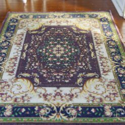 Modern Persian miniature rug with dark floral patterns and intricate borders in rich browns and golds