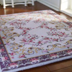 Aubusson-style miniature rug with floral scrolls in soft pastel colors