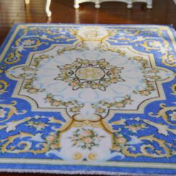 French Louis XV miniature rug with ornate scrolls and floral accents in blue and gold