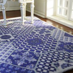Blue and white miniature rug with geometric and checkered patterns