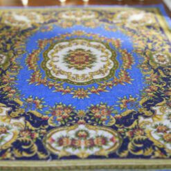 Modern Chinese-inspired miniature rug with floral motifs in blue, red, and gold