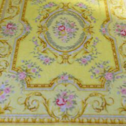 Light yellow Victorian rug with floral details and golden accents