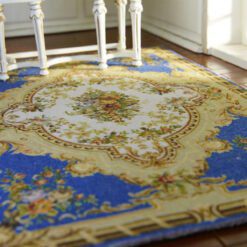 Classic blue Aubusson rug with floral details and a central medallion design.