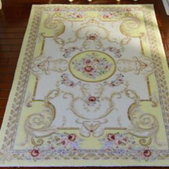 Light yellow Victorian rug with floral motifs and golden accents